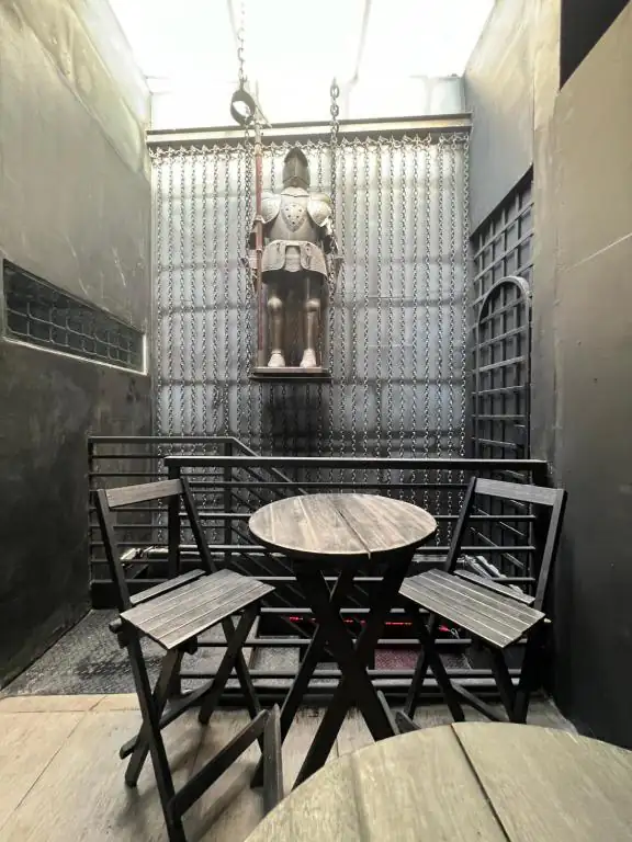 a table and chairs in a room with a statue at Castle of Vibes - Hostel in Rio de Janeiro