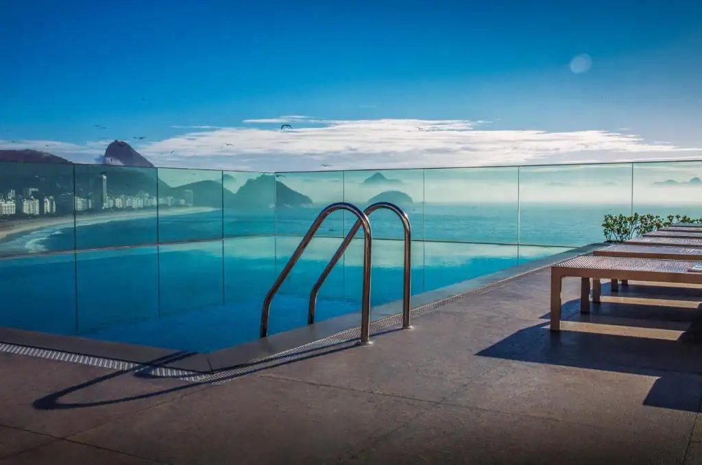 a balcony with a table and a view of the ocean at Miramar By Windsor Copacabana in Rio de Janeiro