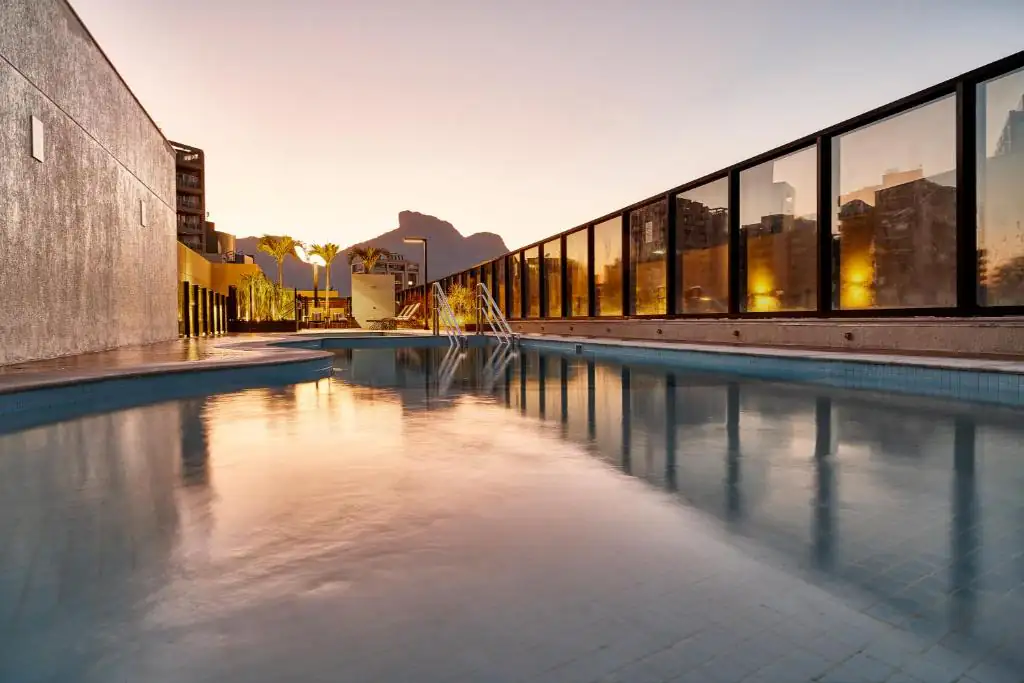 a pool of water in front of a building at Radisson Rio de Janeiro Barra in Rio de Janeiro
