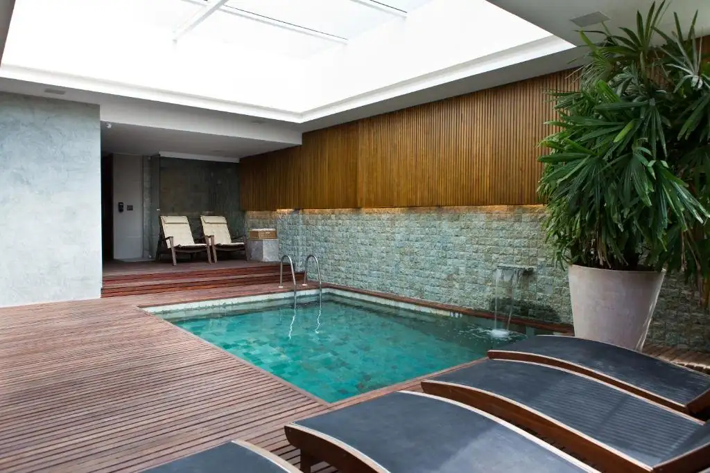 Indoor pool and loungers at Ritz Leblon