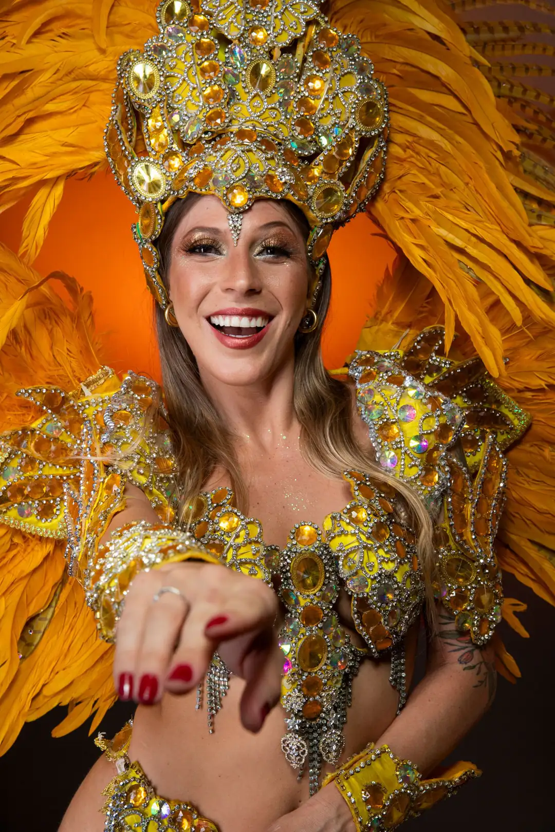 Smiling Carnival performer wearing an ornate feathered costume in Rio de Janeiro