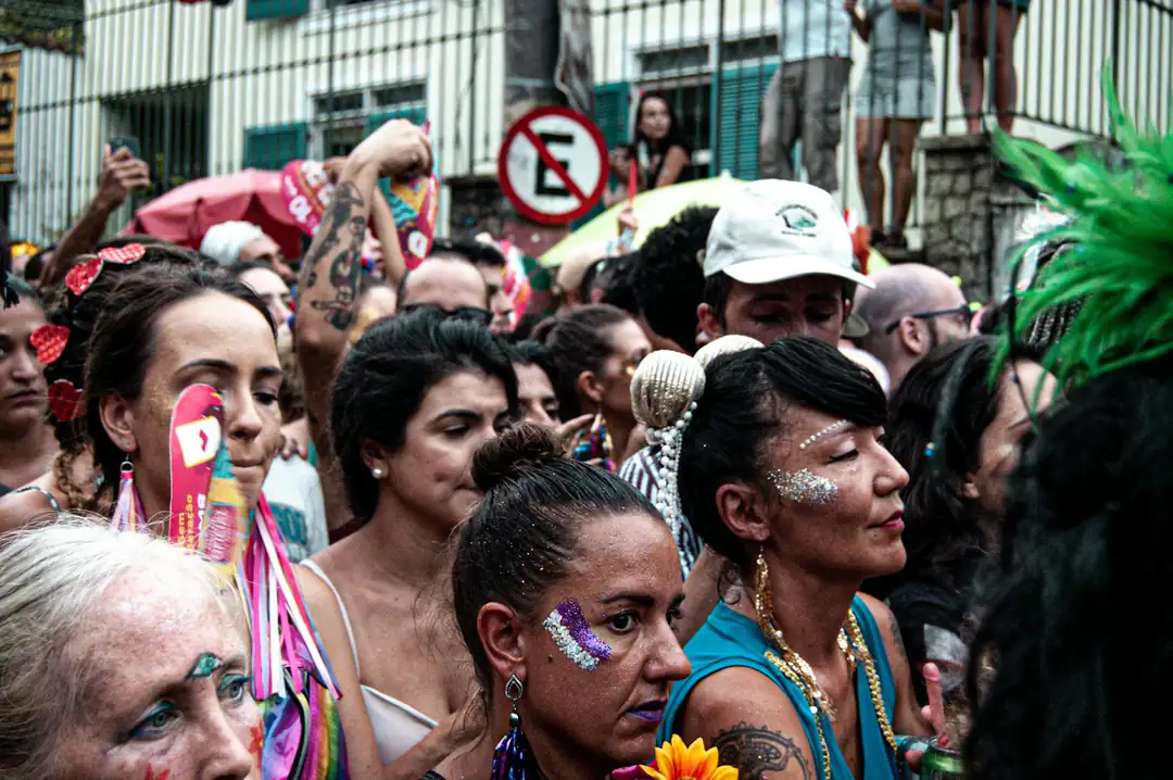 Costumed revellers walking through a Rio de Janeiro street Carnival crowd