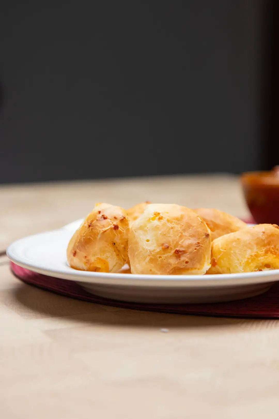 Fresh pão de queijo on a white plate