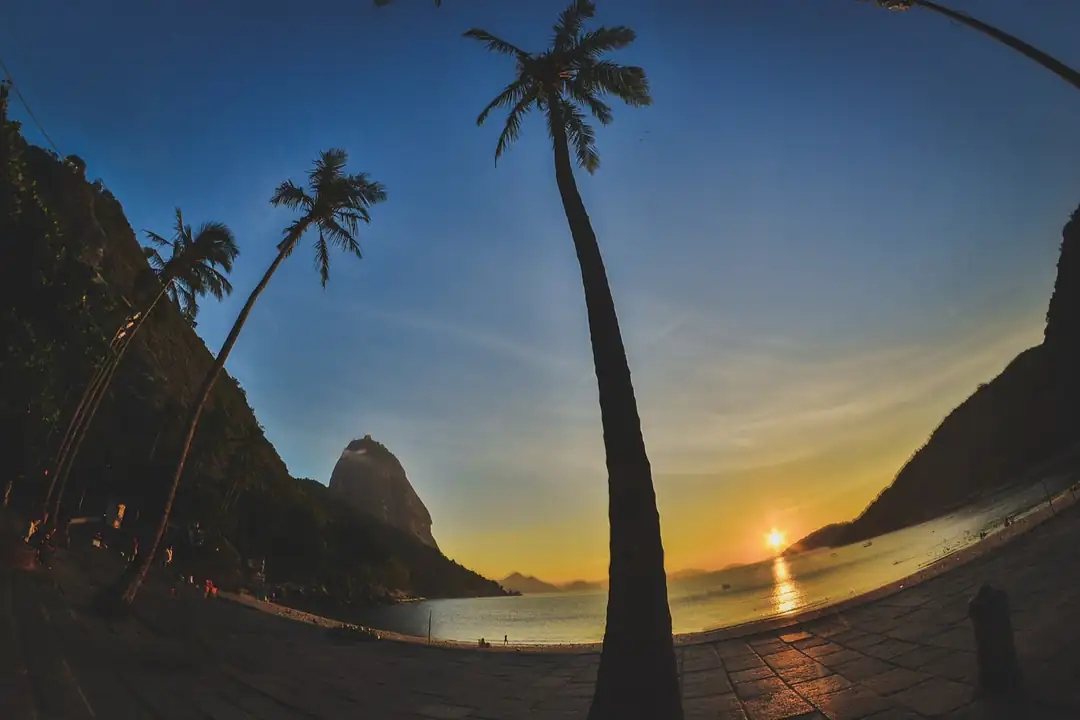 Praia Vermelha beach at sunset beneath the mountains